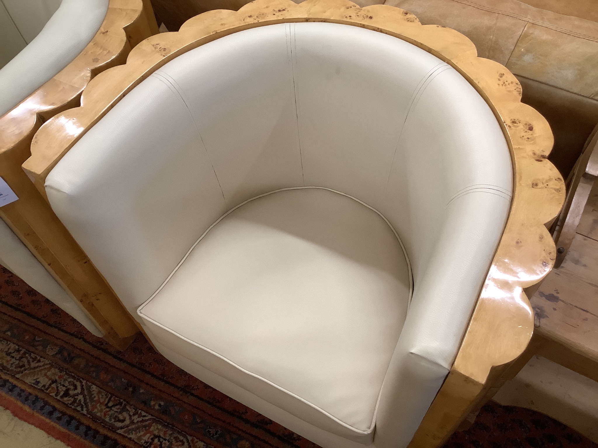 A pair of Art Deco style tub framed cream leather and maple chairs, width 84cm, depth 66cm, height 85cm